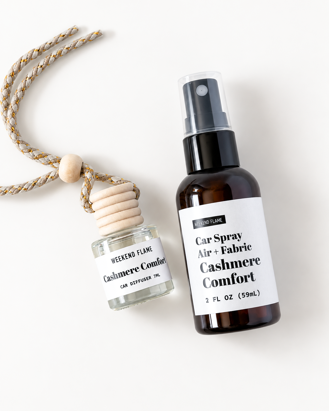 A car spray and matching fabric car diffuser set by Weekend Flame, featuring an amber spray bottle and a small glass reed diffuser with a wooden plug and rope, both labeled 'Cashmere Comfort'.