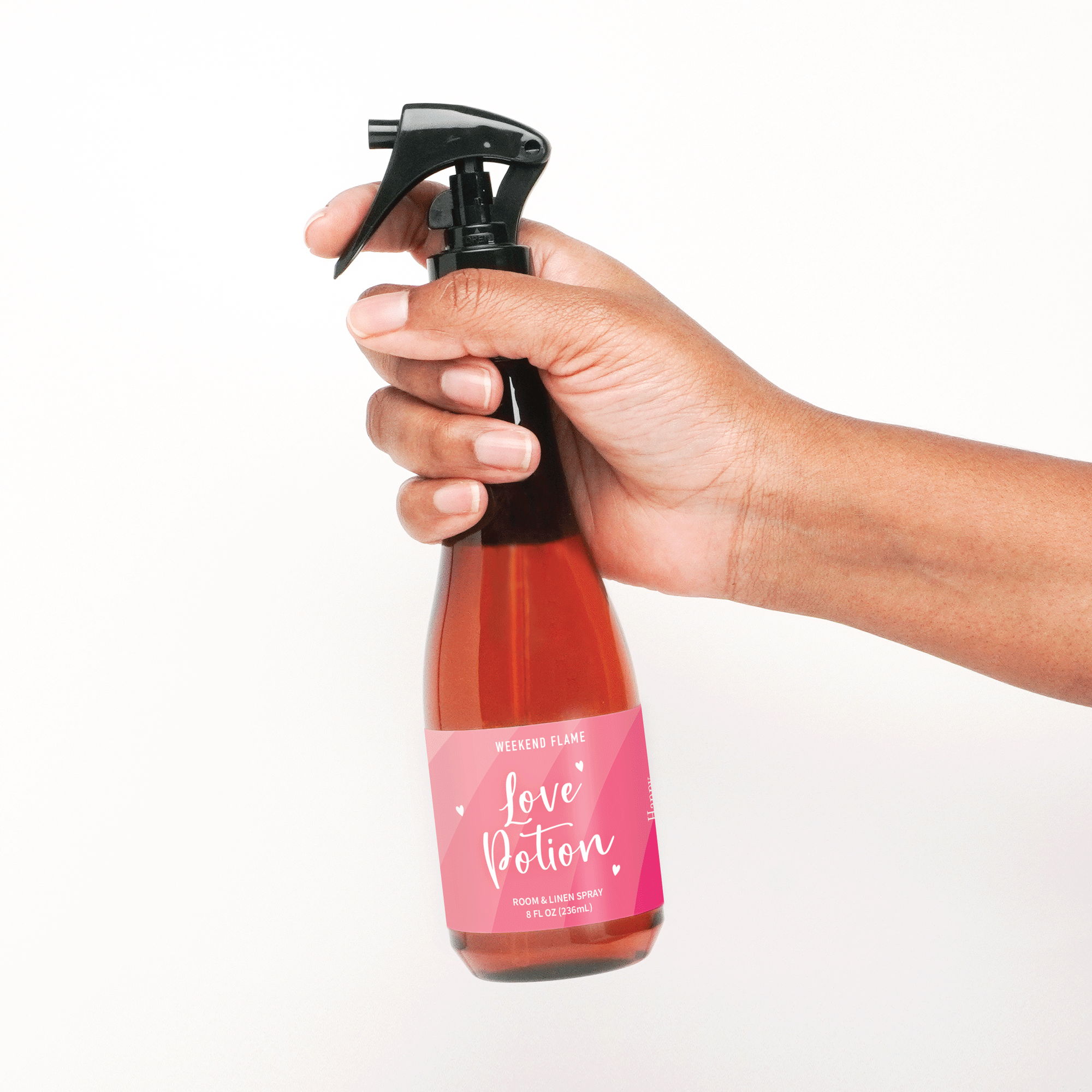 Valentines Day themed room and linen spray with pink label and white text that reads love potion