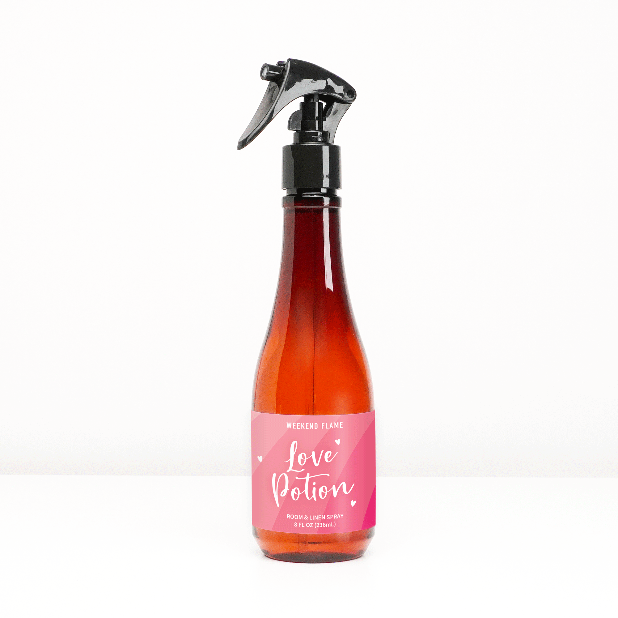 Valentines Day gift room and linen spray with pink label and white text that reads love potion