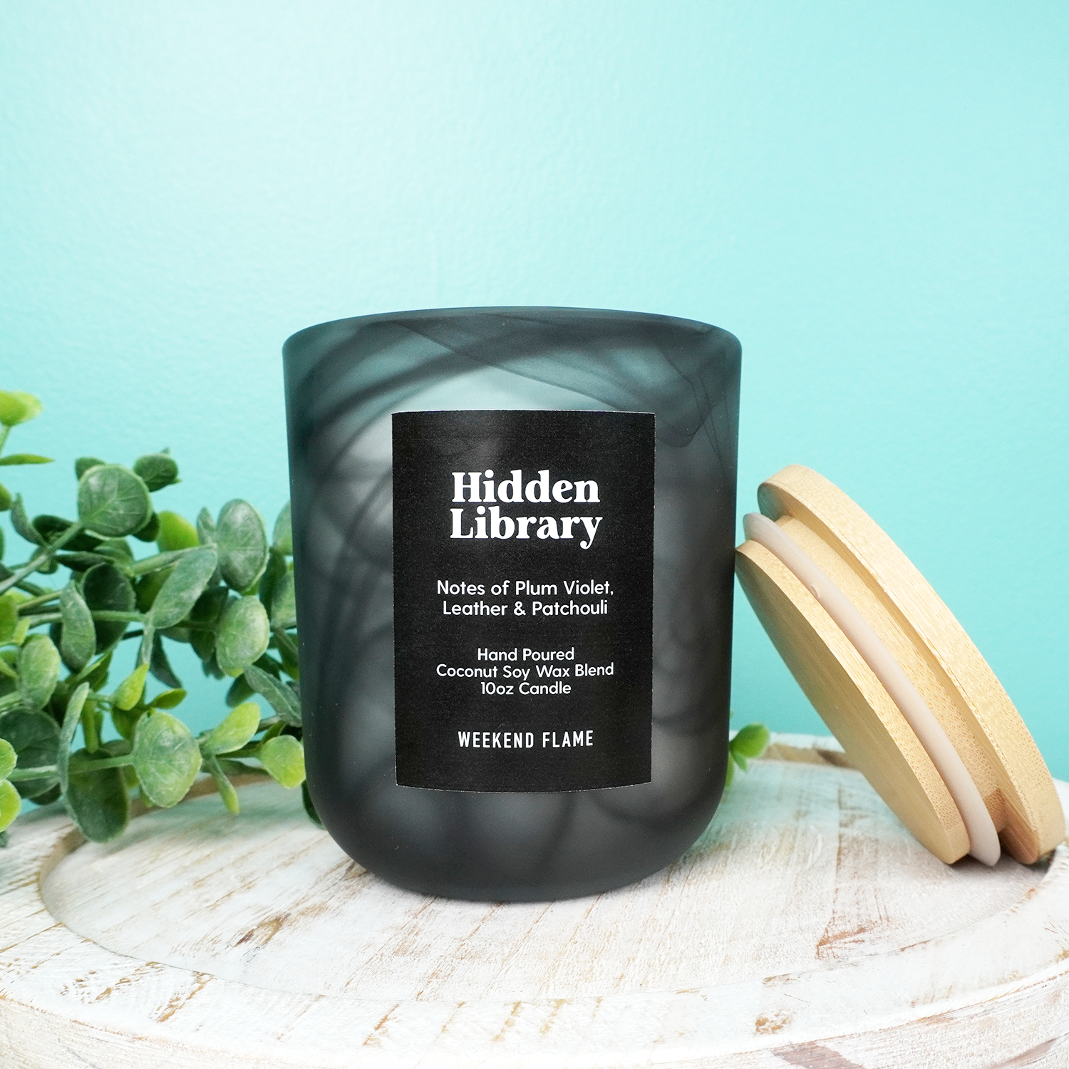 Hand poured scented candle in black swirl tumbler jar.