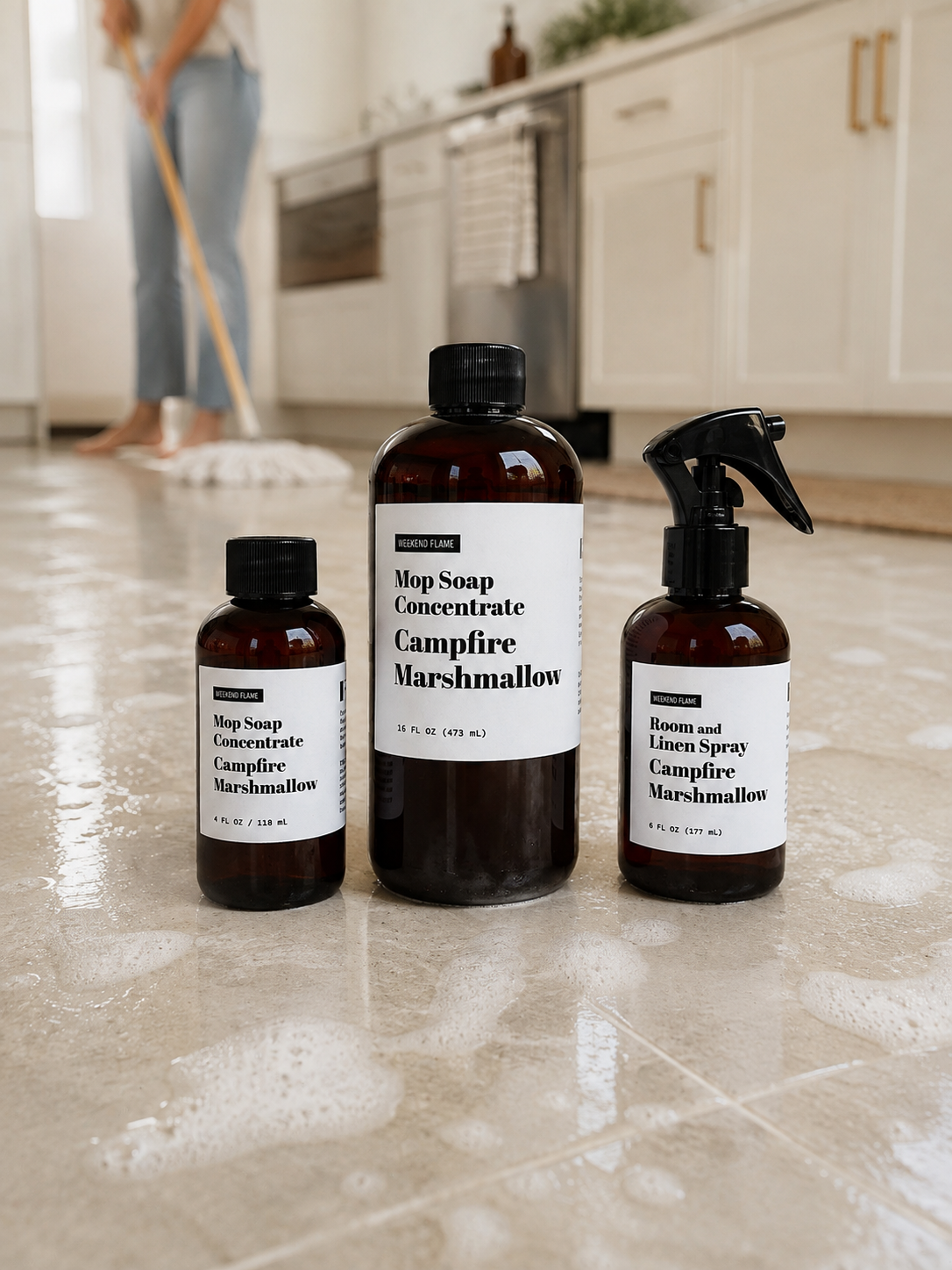 Toasted Marshmallow Mop Soap Concentrate displayed on a lightly sudsy tile floor with a neutral mop in the background.