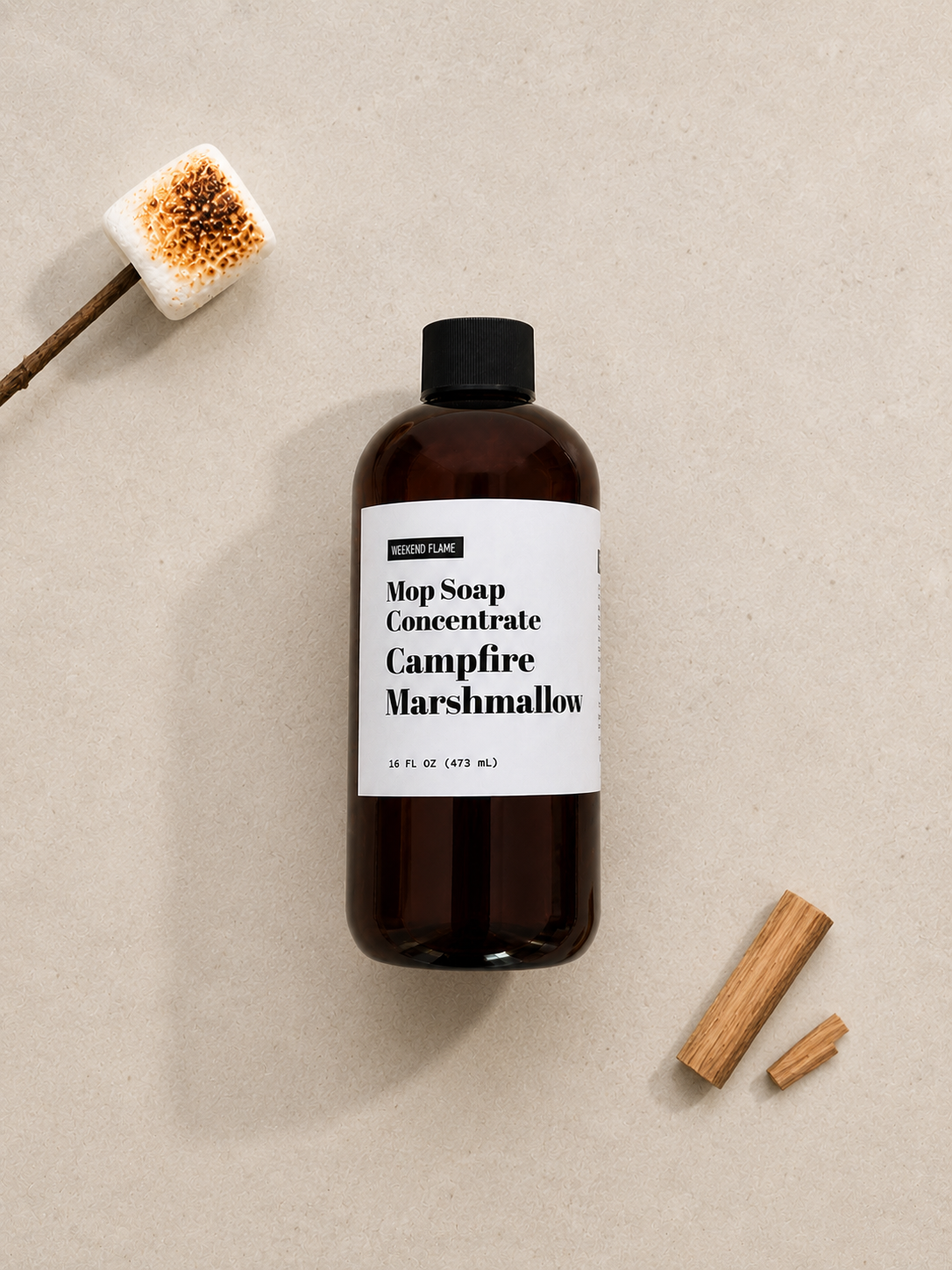 Overhead flat lay of Toasted Marshmallow Mop Soap Concentrate styled with minimal toasted marshmallows and roasting sticks.