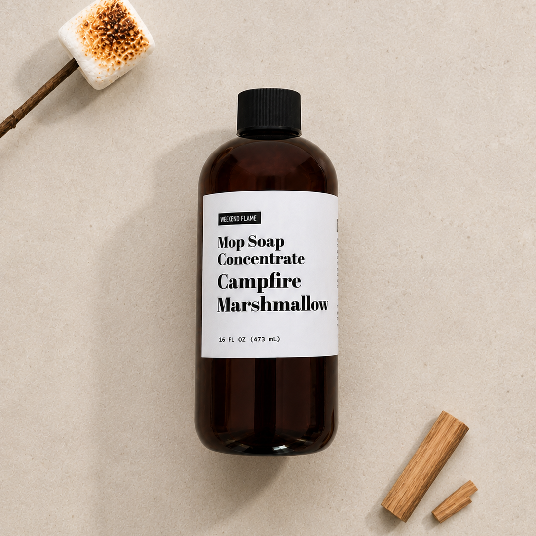 Overhead flat lay of Toasted Marshmallow Mop Soap Concentrate styled with minimal toasted marshmallows and roasting sticks.