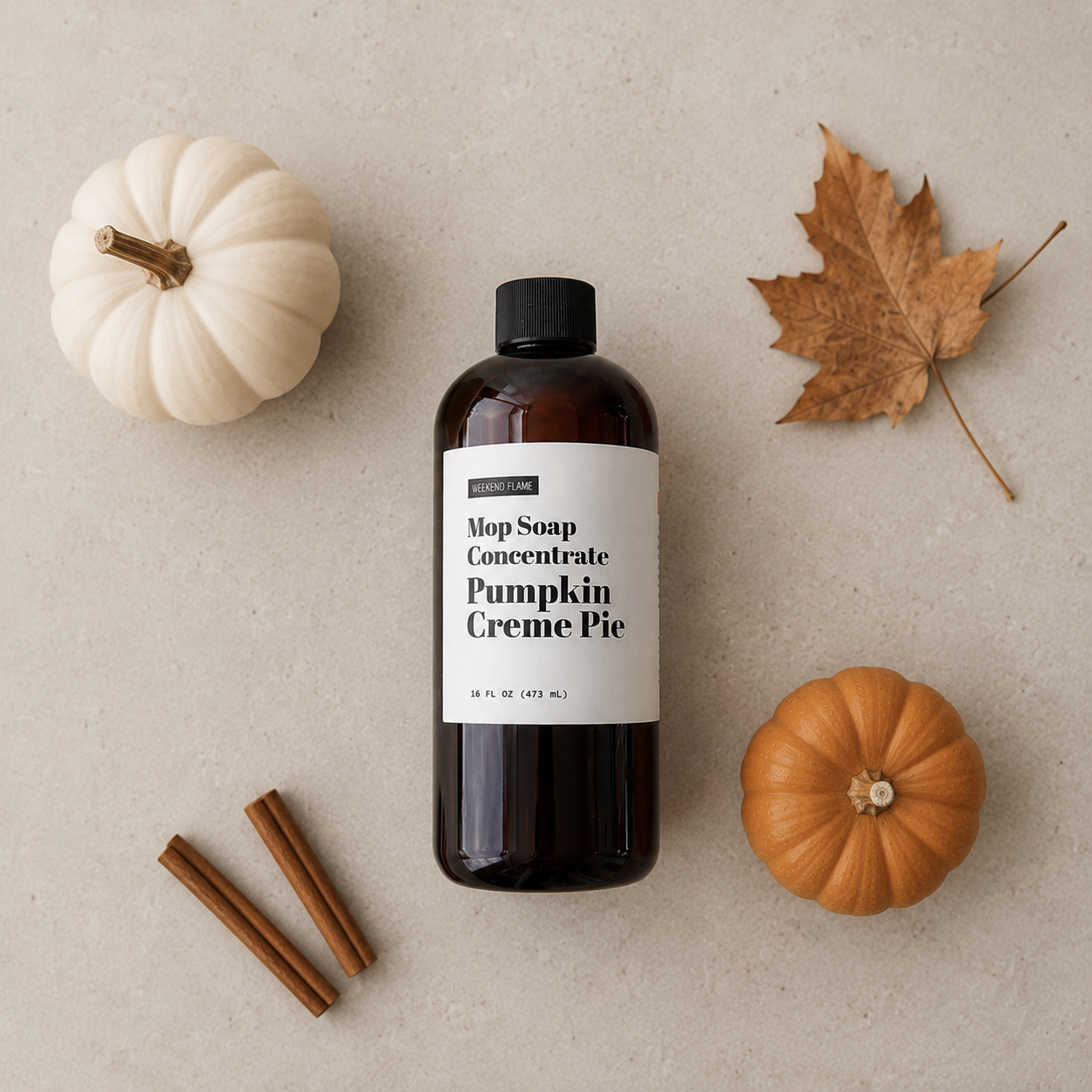 Pumpkin Creme Pie Mop Soap Concentrate in an amber 16 ounce bottle styled with minimal pumpkin and fall accents.